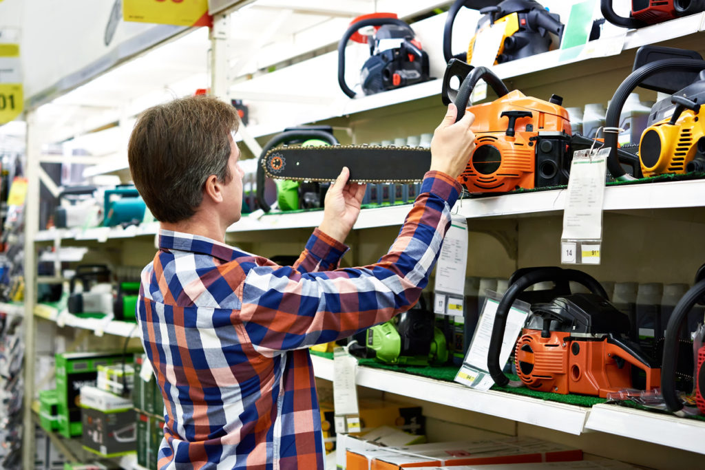 Man chooses a gasoline saw