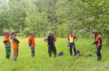 Instructor and participants of a lumberjack training.